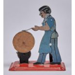 A  mechanical lithographed tinplate figural knife grinder toy, c mid 20th c Slight wear to paint,