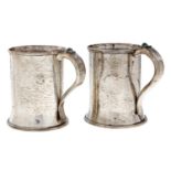 A pair of Arts & Crafts silver mugs, hammer textured, the handle set with chrysoprase, 12cm  h, by
