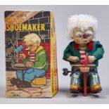 A Japanese mechanical lithographed tinplate and fabric clockwork - Little Shoemaker toy, Alps