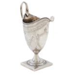 A George III helmet shaped silver cream jug, with reeded rim and handle, engraved with festoons,