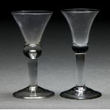 Two English wine glasses, mid 18th c, with bell bowl, one with solid base with tear, on solid stem