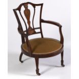 An Edwardian mahogany, rosewood and inlaid open armchair, with flared, curved back, padded round