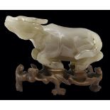 A Chinese stone carving of a yak, 22.5cm l, wood stand Minor flaws, but in substantially good