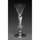 An English wine glass, c1750, the trumpet bowl on composite stem of multi spiral air twist over