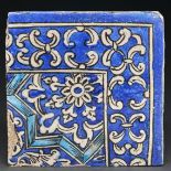 An Islamic corner tile, painted in blue, black and turquoise, 21.5 x 21.5cm Surface damage as