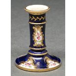 An English porcelain toy candlestick, probably Coalport, c1820, painted with flowers reserved on a