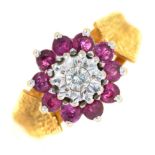 A ruby and diamond cluster ring,  in 18ct gold with textured shoulders,  Sheffield 1975, 5.6g,