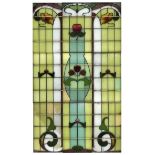 An Edwardian art nouveau leaded glass window, 1903, of stylised floral design, composed of nine