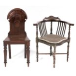 A Victorian oak hall chair, with arched back, seat height 44cm and an Edwardian carved and stained-