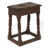 A Charles II oak joined stool, 17th c, with lunette carved rails and turned legs united by