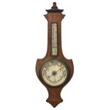 An Edwardian rosewood, sycamore and harewood inlaid aneroid barometer, of shield shape with