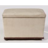 A Victorian fabric covered ottoman, of sarcophagus shape on mahogany ovolo base with recessed