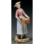 A Royal Copenhagen figure of a street vendor, late 18th c, as a young woman in a yellow bonnet