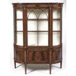 A finely figured and carved mahogany china cabinet, early 20th c, with lancet arched glazing bars to