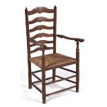 A Victorian ash ladder back elbow chair, rush seated, seat height 44cm Legs slightly uneven