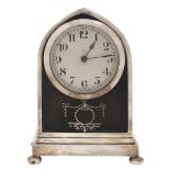 A George V lancet arched silver and tortoiseshell inset mantel timepiece, on bun feet, French