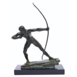 A bronze sculpture of an archer, on sloping rock, naked save for loincloth, uneven rich black and