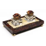 A Victorian tortoiseshell and mother of pearl inkstand, with pair of glass inkwells, brass feet,