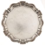 A George V silver salver, on three feet, 24.5cm diam, by Robert Pringle & Sons, London 1926, 16ozs