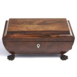 An early Victorian rosewood tea chest, c1840, of sarcophagus shape, the fitted interior retaining