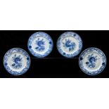A set of four Chinese export blue and white plates, late 18th c, painted with a flower and curling