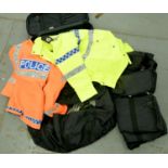 Two hi-visibility police jackets, contained within a black trolley case and a quantity of black