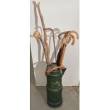 A green painted fabric cylindrical Fire Water bucket with leather handle, the body bearing partial