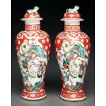 A pair of Chinese famille verte vases and covers, 19th c, decorated with dignitaries or warriors