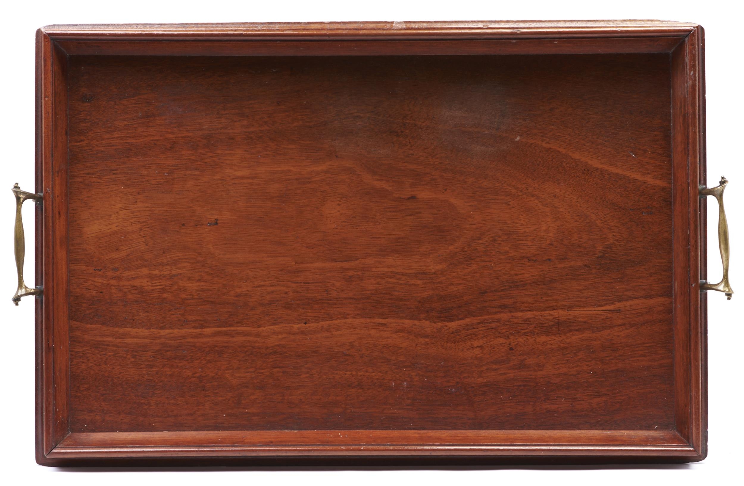 An Edwardian mahogany two handled tray, c1910, of rectangular outline with flared border and pair of