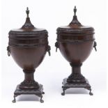 A pair of shield shaped mahogany urns and covers, 20th c, in neo classical style with brass vase