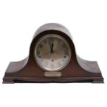 An oak mantel clock, c1930, with chiming movement, engraved tablet inscribed N & N.C.S. presented by