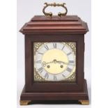A reproduction mahogany basket top mantle clock, with brass dial, 24cm h excluding handle and a