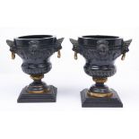 A pair of French parcel gilt bronze urns, c1870, of ogee form with lion mask handles beneath a