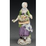 A Meissen figure of a street vendor, 20th c,  14cm h, underglaze blue crossed swords Lacking left