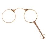 A gold lorgnette, c1900, 95mm l, marked 9ct Good condition action working smoothly and springing