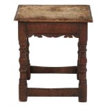 A Charles II oak joined stool, 17th c, the rails with notched mouldings, on ringed baluster legs and