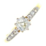 A diamond ring, the larger old cut diamond flanked by diamond set shoulders, gold hoop marked 18ct &