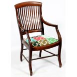 An Arts and Crafts mahogany elbow chair, c1910, with curved splats, shaped arms and slightly