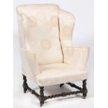 A wingback armchair, early 20th c,  in George III style on spiral turned and dark stained wood