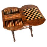 A Victorian bow ended walnut and inlaid work table, the quarter veneered fold over top inlaid for