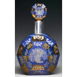 A silver colour metal mounted blue and amber flashed and wheel engraved faceted glass decanter and