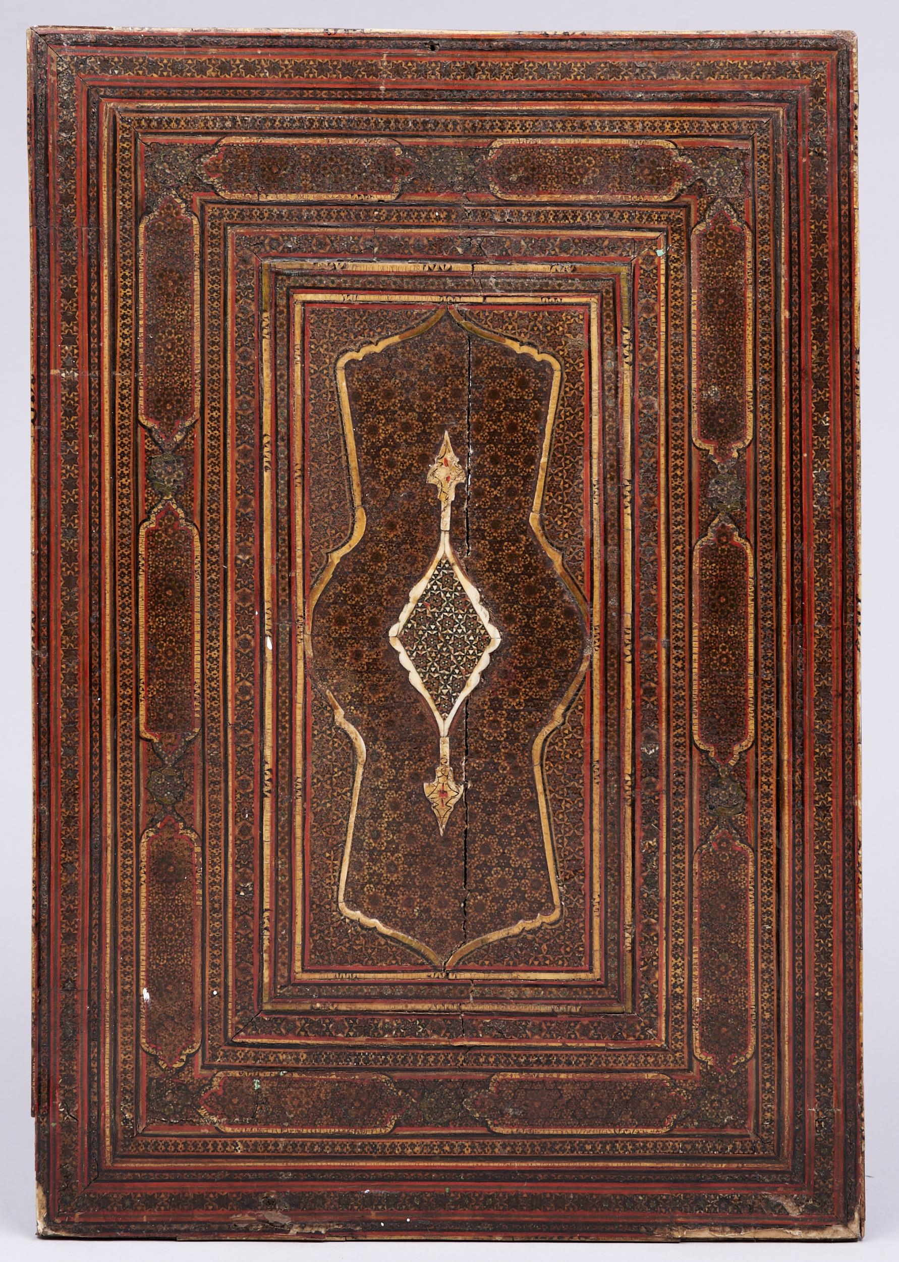 A Qajar inlaid and lacquered polychrome khatamkari mirror case back, 19th c, 54 x 37cm Much old