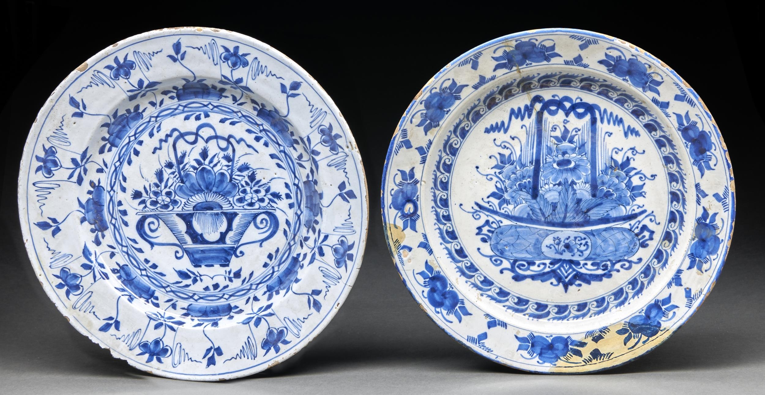 Two English Delftware dishes, c1770, painted with a central flower filled basket bordered by