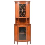 An Edwardian bow fronted satinwood and inlaid standing corner cabinet, with pear drop cornice and