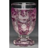 A Bohemian cranberry flashed and wheel engraved spa glass, c1860, five of the six sides engraved