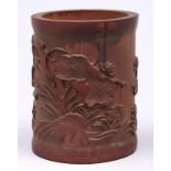 A Chinese bamboo brush pot, carved with lilies and rippling waters, 15.5cm h Two shrinkage cracks