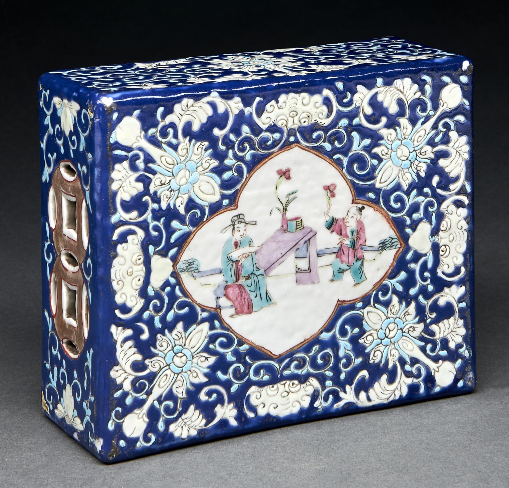 A Chinese famille rose pillow, 20th c, enamelled in turquoise with bats and lotus on blue ground,