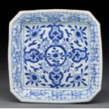 A Chinese blue and white square dish, Qing dynasty, 18th c, with flared, fluted sides, the border