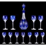 A blue cased and cut glass decanter and stopper and eleven goblets en suite, 20th c, decanter and