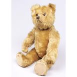 A head turning teddy bear, attributed to Steiff, circa mid 20th c, of blond mohair with beige felt